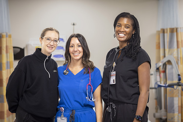 caregiver page three care team members Three PACE female caregivers in a clinic setting
